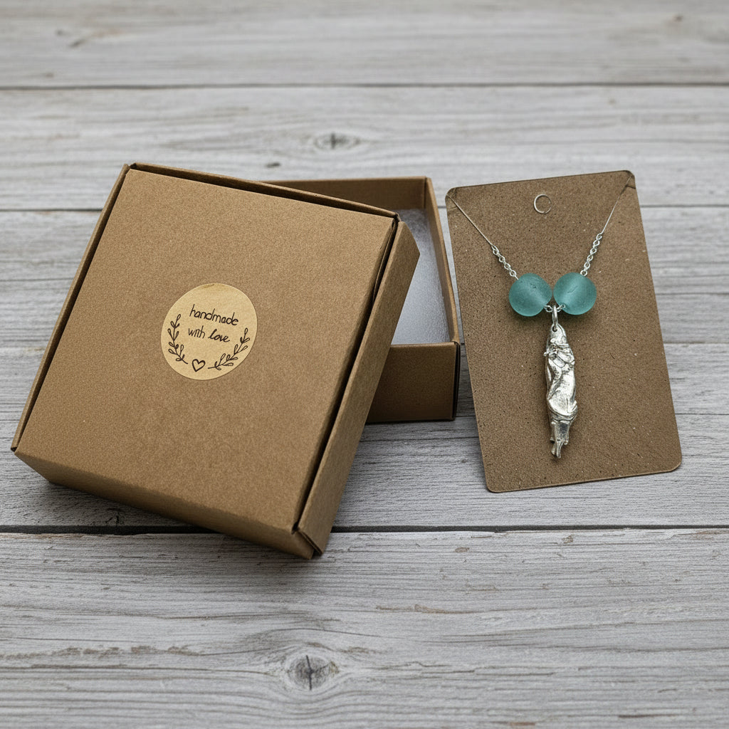 Fine silver handmade mermaid pendant on a sterling silver chain, accented with recycled Ghana glass beads.