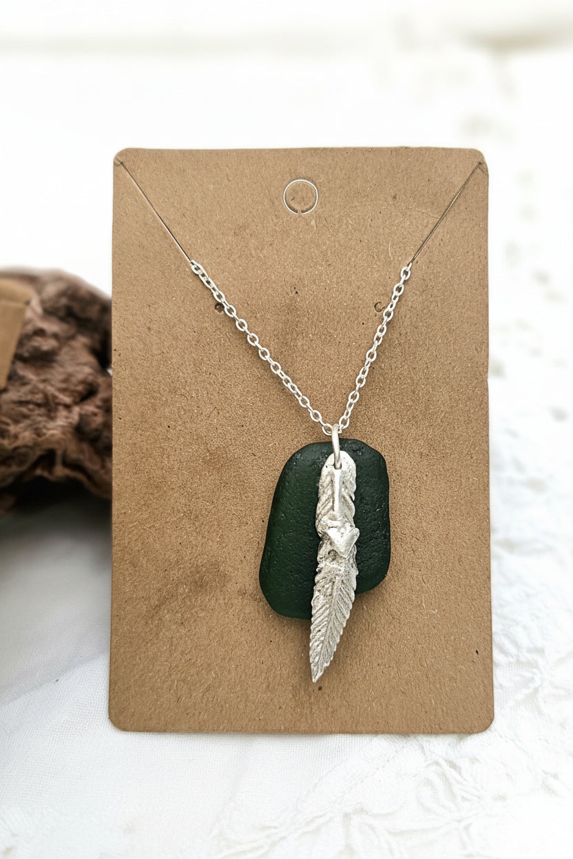 Authentic North East English sea glass necklace featuring a handcrafted fine silver charm on a sterling silver chain.