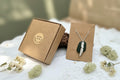 Authentic North East English sea glass necklace featuring a handcrafted fine silver charm on a sterling silver chain.