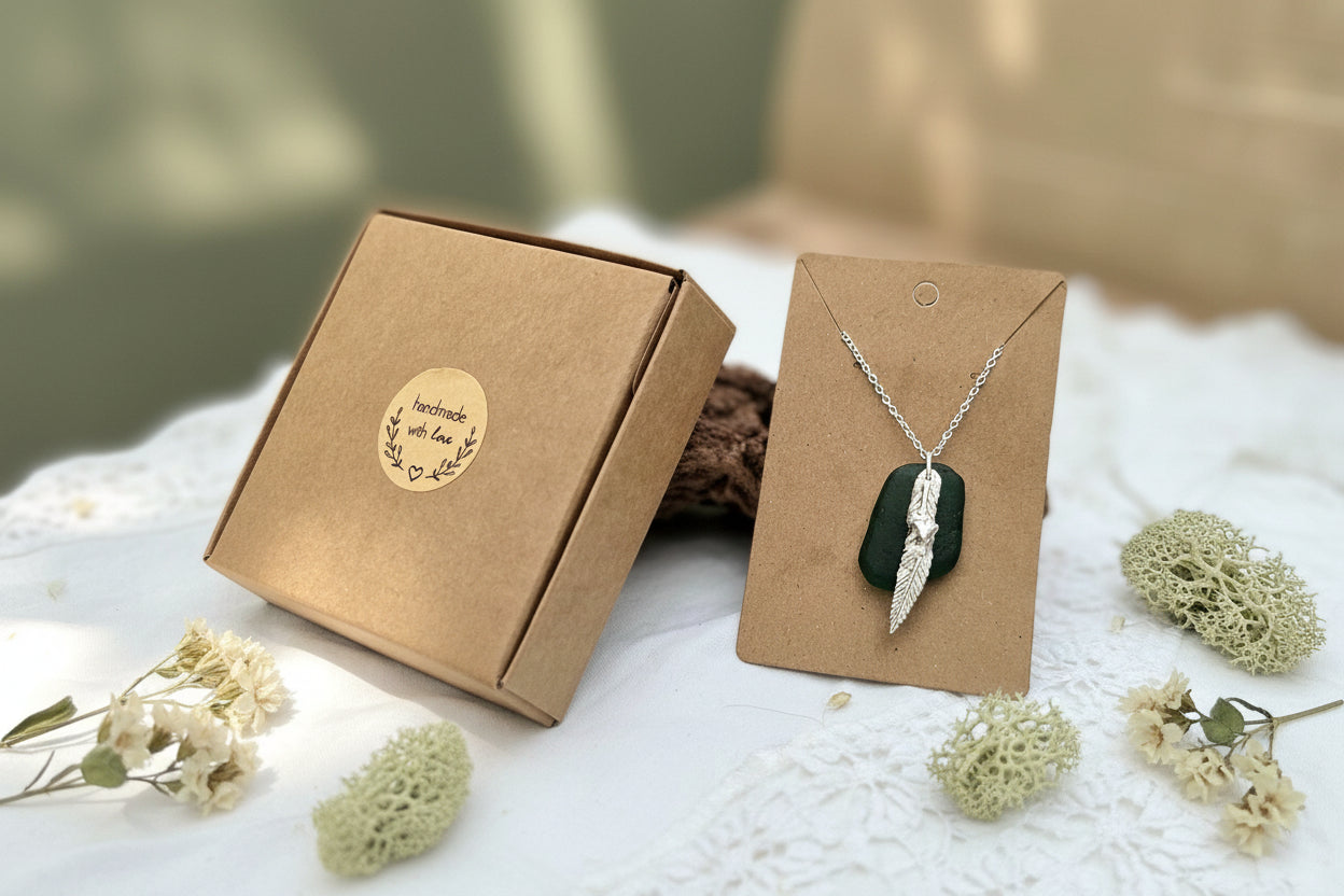 Authentic North East English sea glass necklace featuring a handcrafted fine silver charm on a sterling silver chain.