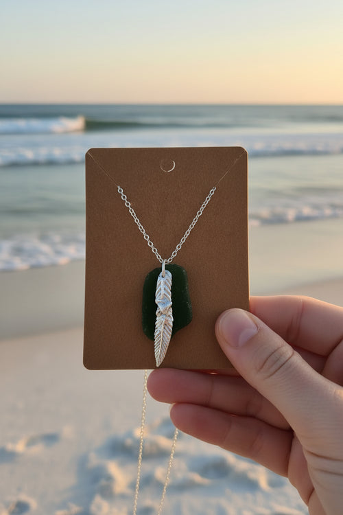 Authentic North East English sea glass necklace featuring a handcrafted fine silver charm on a sterling silver chain.