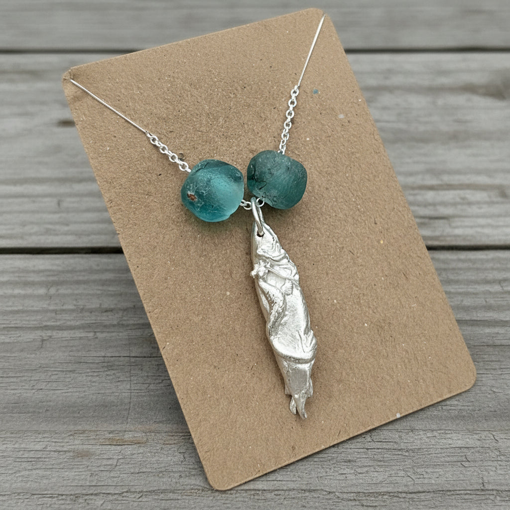 Fine silver handmade mermaid pendant on a sterling silver chain, accented with recycled Ghana glass beads.
