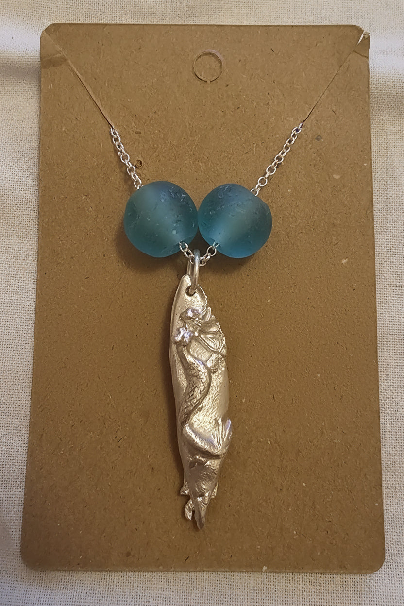 Fine silver handmade mermaid pendant on a sterling silver chain, accented with recycled Ghana glass beads.